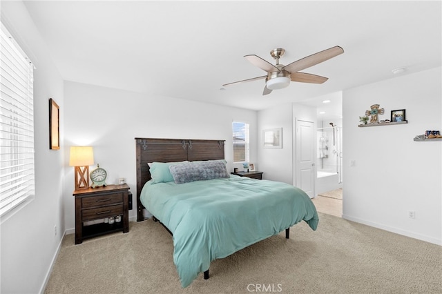 bedroom featuring carpet floors, baseboards, and ensuite bathroom