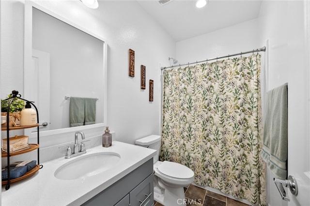 bathroom featuring toilet, a shower with curtain, and vanity