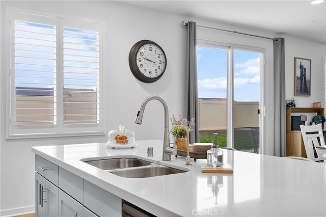 kitchen featuring light countertops and a sink