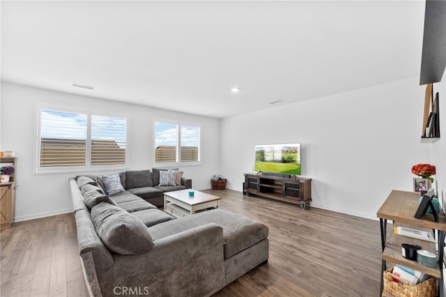 living area featuring recessed lighting, baseboards, and wood finished floors