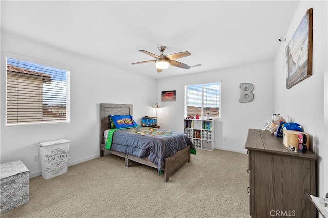 bedroom with light carpet, a ceiling fan, and baseboards