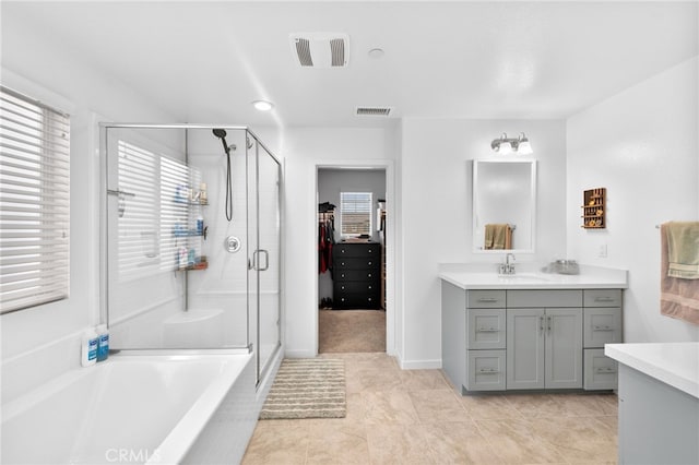 full bath featuring a healthy amount of sunlight, visible vents, vanity, and a shower stall