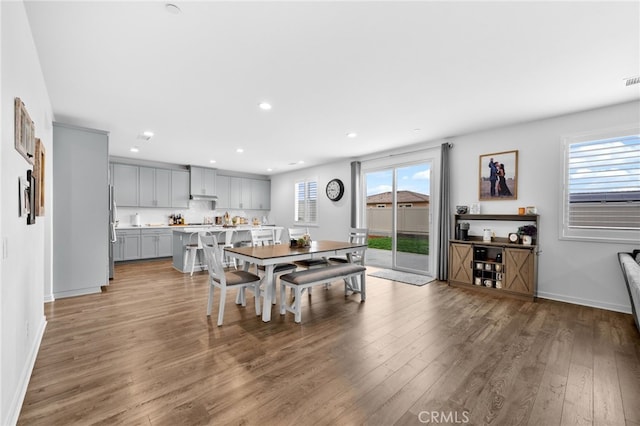 dining area featuring baseboards, wood finished floors, visible vents, and recessed lighting