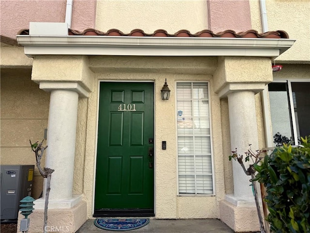 property entrance with stucco siding