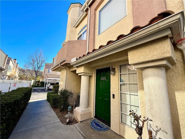 property entrance featuring stucco siding