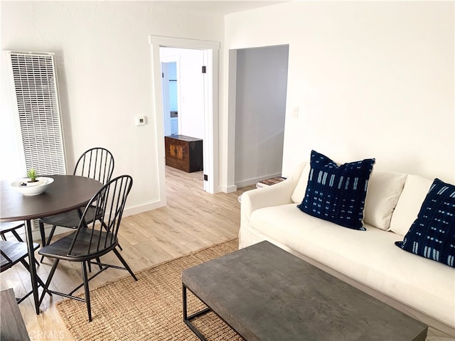3443 W Blvd, Los Angeles, CA 90016 - living room with a heating unit, light wood finished floors, and baseboards