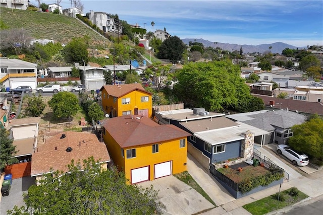 drone / aerial view featuring a residential view and a mountain view