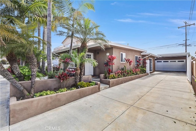 309 W Avenida Palizada, San Clemente, CA 92672 - view of front facade featuring driveway, an outdoor structure, and stucco siding