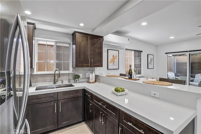 309 W Avenida Palizada, San Clemente, CA 92672 - kitchen with a peninsula, light countertops, dark brown cabinets, stainless steel refrigerator with ice dispenser, and a sink