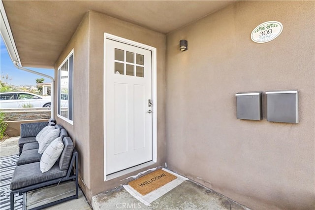 doorway to property with stucco siding