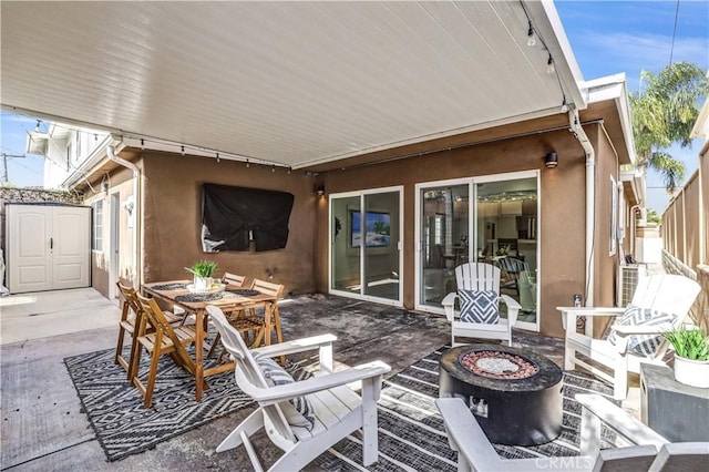 309 W Avenida Palizada, San Clemente, CA 92672 - view of patio / terrace with outdoor dining space, an outdoor structure, a fire pit, and a shed