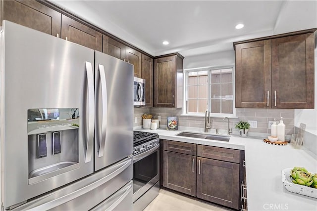 309 W Avenida Palizada, San Clemente, CA 92672 - kitchen with dark brown cabinetry, a sink, light countertops, appliances with stainless steel finishes, and tasteful backsplash
