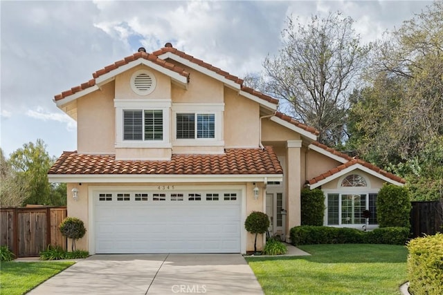 mediterranean / spanish-style house featuring driveway, a front yard, fence, and stucco siding