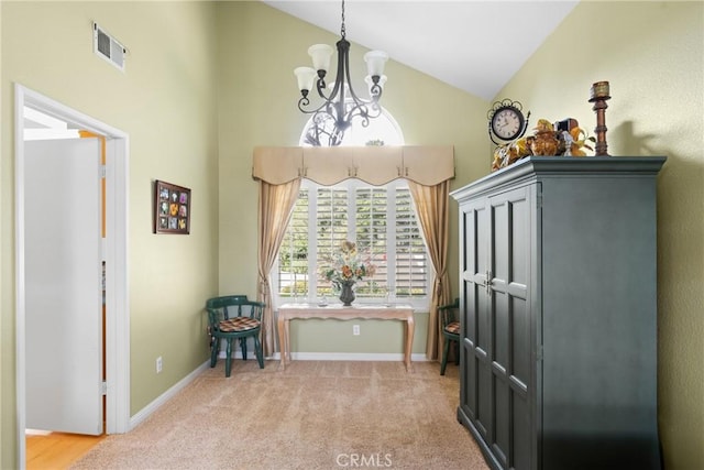 dining area featuring a notable chandelier, baseboards, visible vents, and light colored carpet