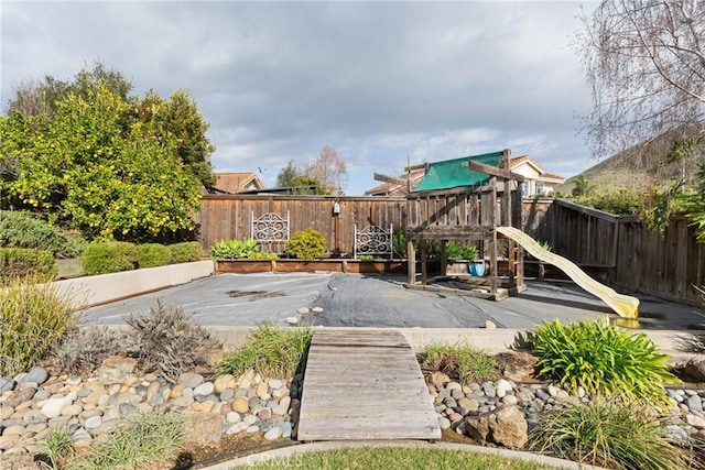 view of jungle gym with a fenced backyard