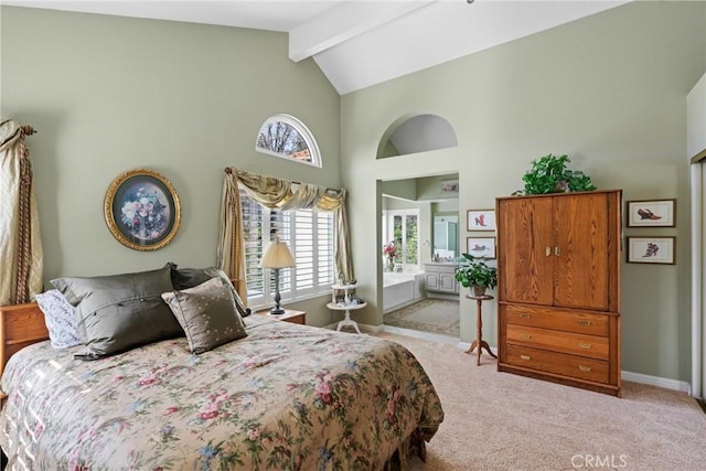 carpeted bedroom with high vaulted ceiling, beam ceiling, connected bathroom, and baseboards