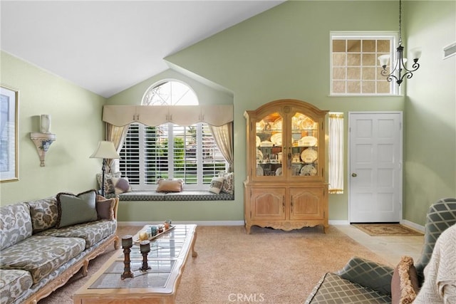 living room with lofted ceiling, carpet floors, baseboards, and a notable chandelier