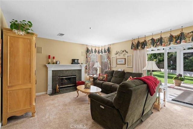 living room with a fireplace with flush hearth, visible vents, baseboards, and light colored carpet