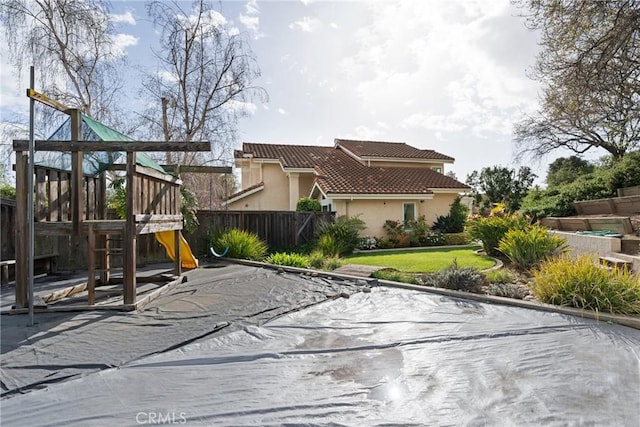 view of play area with fence and a lawn