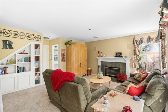 living area with a fireplace, visible vents, and light colored carpet