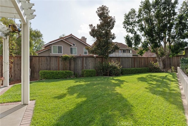 view of yard with a fenced backyard and a pergola