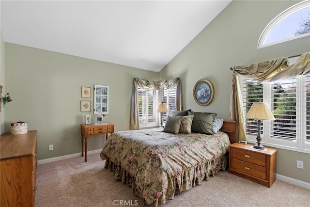 bedroom with high vaulted ceiling, baseboards, and light colored carpet