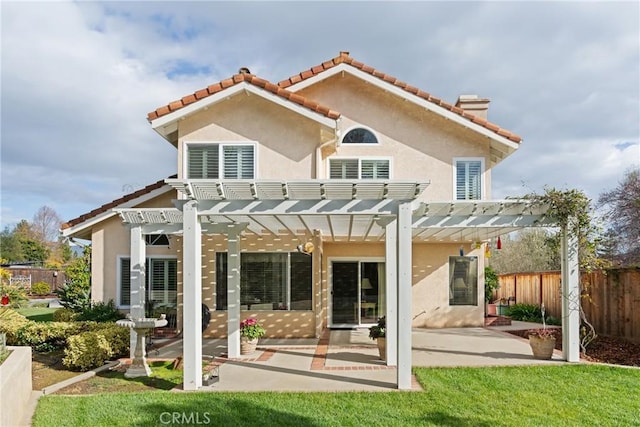 back of house with a tile roof, a patio, stucco siding, fence, and a pergola