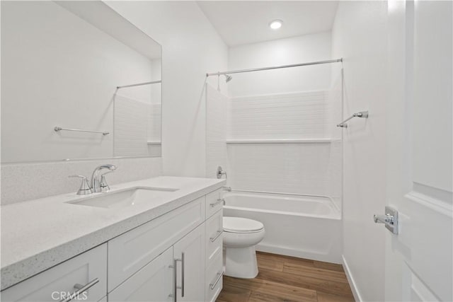 bathroom with vanity, shower / bathing tub combination, wood finished floors, and toilet