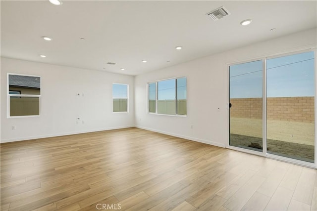 empty room featuring baseboards, recessed lighting, visible vents, and light wood-style floors