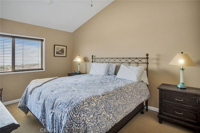 carpeted bedroom with vaulted ceiling and baseboards