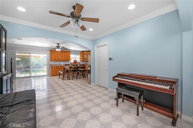 living room with recessed lighting, baseboards, arched walkways, and ornamental molding