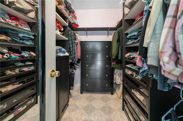 spacious closet featuring light tile patterned floors