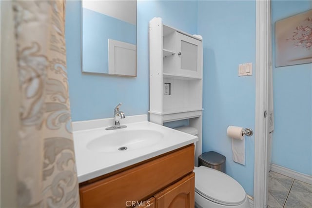 bathroom featuring toilet and vanity