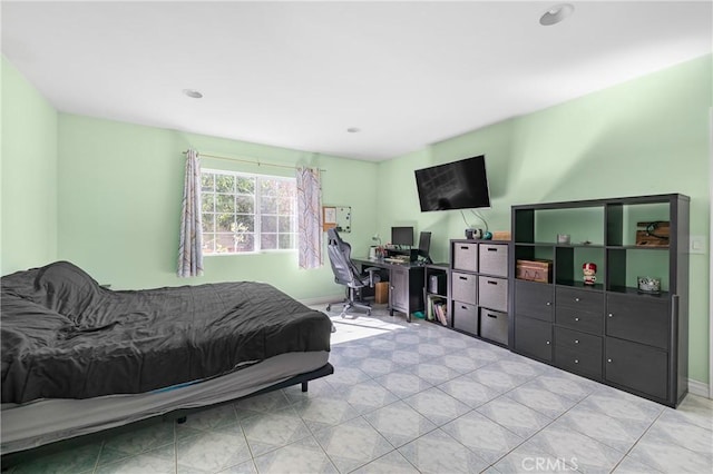 bedroom with tile patterned flooring and baseboards