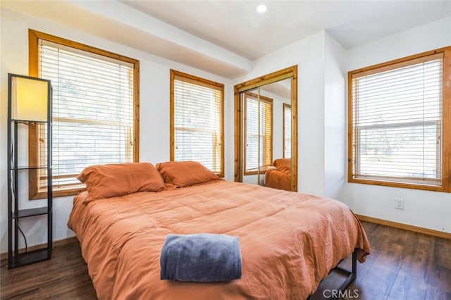 bedroom featuring dark wood-type flooring and baseboards