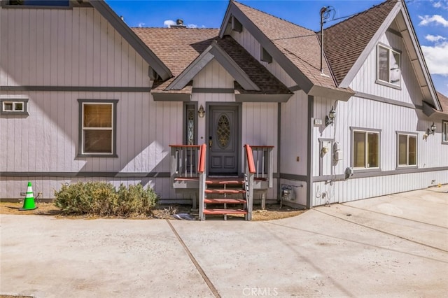 view of front of home featuring roof with shingles