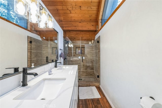 full bathroom with wood finished floors, a sink, wood ceiling, and a shower stall