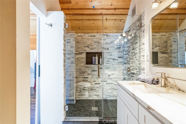 bathroom featuring wooden ceiling, a shower stall, and vanity