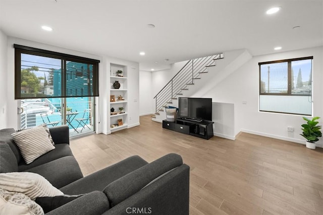1923 N Gower St, Los Angeles, CA 90068 - living room with stairway, wood finished floors, baseboards, recessed lighting, and built in features