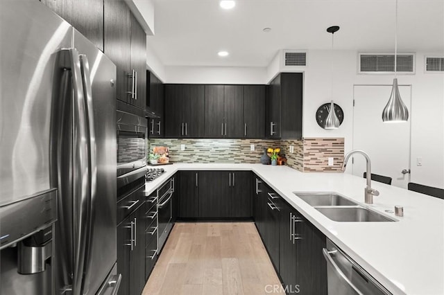 1923 N Gower St, Los Angeles, CA 90068 - kitchen with appliances with stainless steel finishes, a sink, light wood-type flooring, light countertops, and recessed lighting