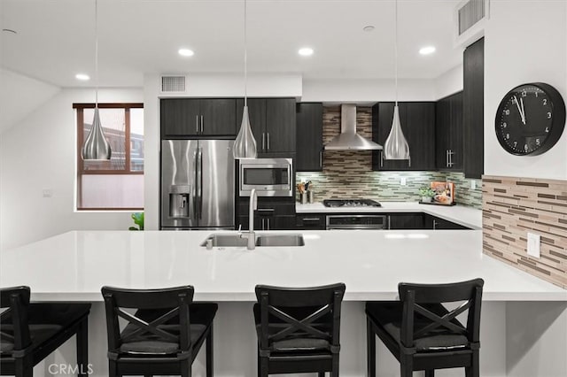 1923 N Gower St, Los Angeles, CA 90068 - kitchen featuring appliances with stainless steel finishes, wall chimney range hood, dark cabinets, a sink, and recessed lighting