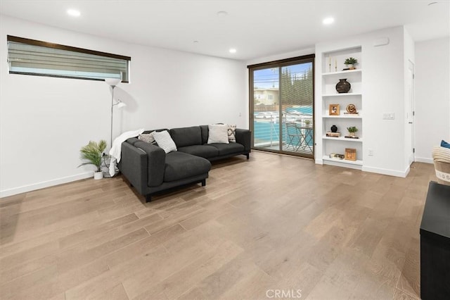 1923 N Gower St, Los Angeles, CA 90068 - living area featuring light wood-type flooring, baseboards, recessed lighting, and built in shelves