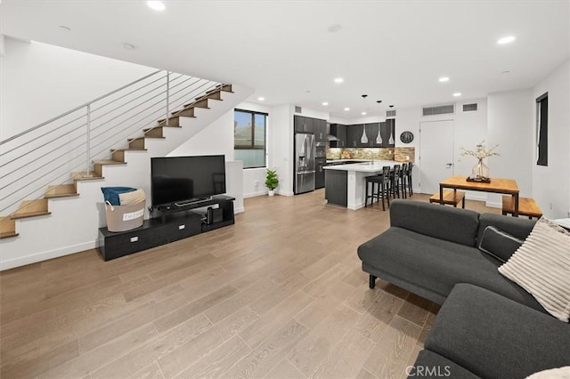 1923 N Gower St, Los Angeles, CA 90068 - living area with stairway, recessed lighting, light wood-type flooring, and baseboards