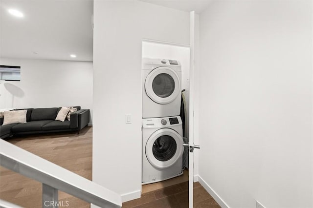 1923 N Gower St, Los Angeles, CA 90068 - washroom with stacked washing machine and dryer, baseboards, recessed lighting, and wood finished floors