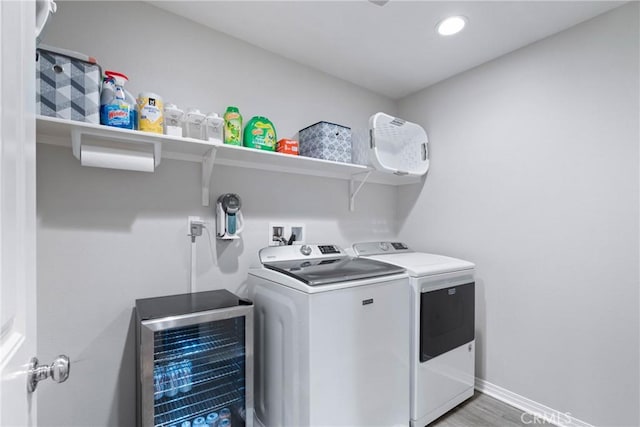 washroom featuring washing machine and clothes dryer, recessed lighting, light wood-style floors, laundry area, and baseboards