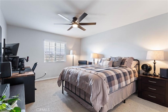 bedroom with light carpet, a ceiling fan, and baseboards