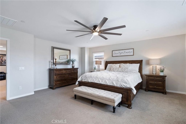 carpeted bedroom with visible vents, baseboards, and a ceiling fan