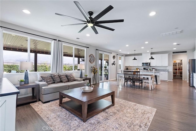 living room featuring visible vents, wood finished floors, and recessed lighting