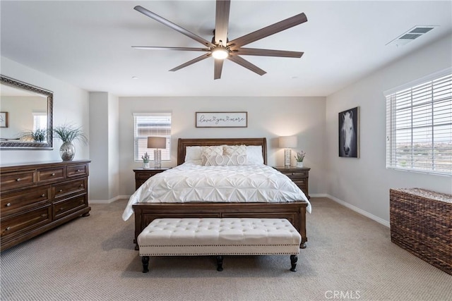 bedroom featuring light carpet, multiple windows, and visible vents