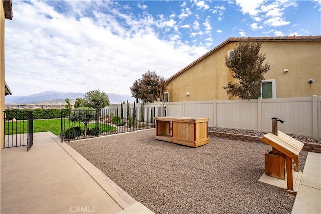 exterior space with a fenced backyard and a mountain view